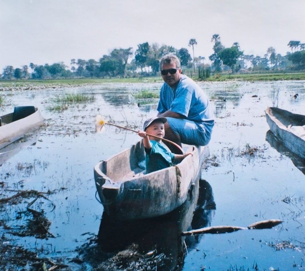 Jake as a child in a mokoro with his father in the Okavango