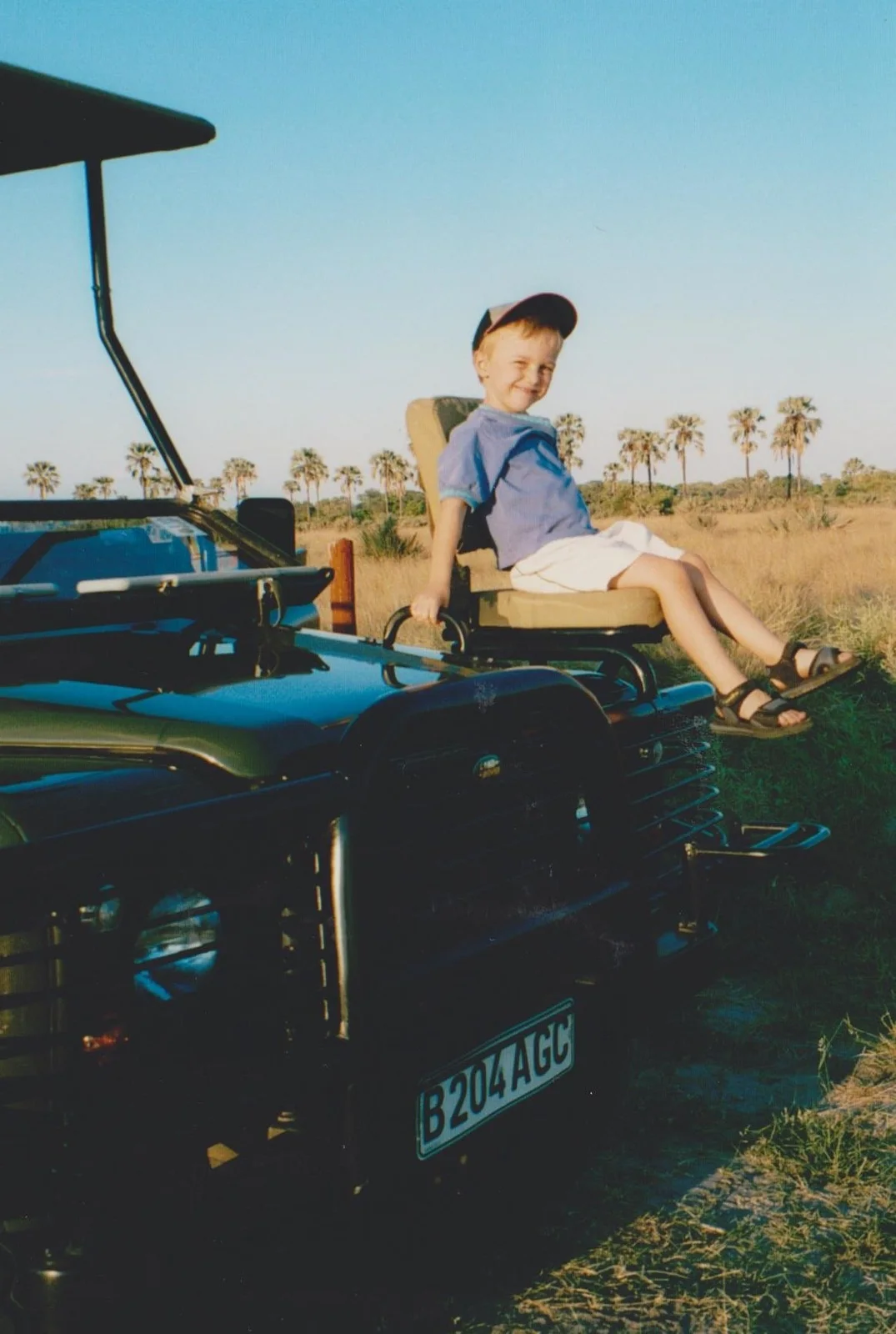 Jake as a child on a game-drive vehicle