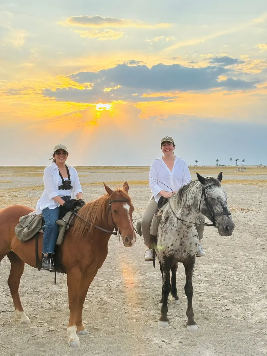 Riders on horseback in Botswana wetlands