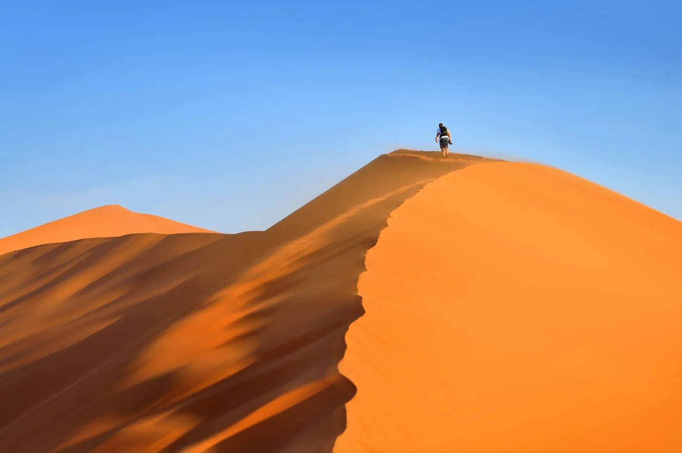 Traveller walking along a Namibian sand dune